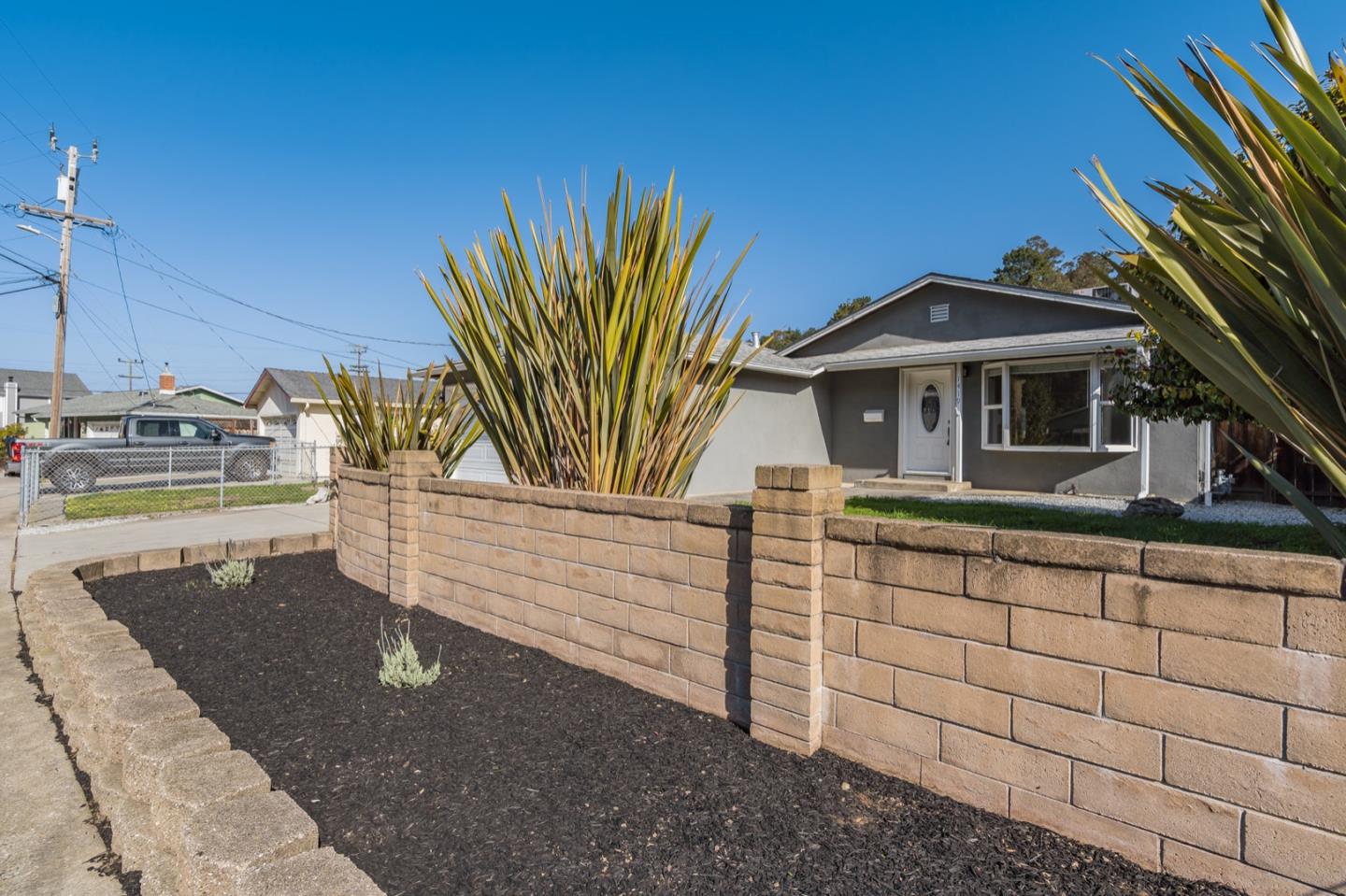 1419 Madeira Drive Pacifica, CA 94044 - Photo 3 of 66 a front view of a house with a garden