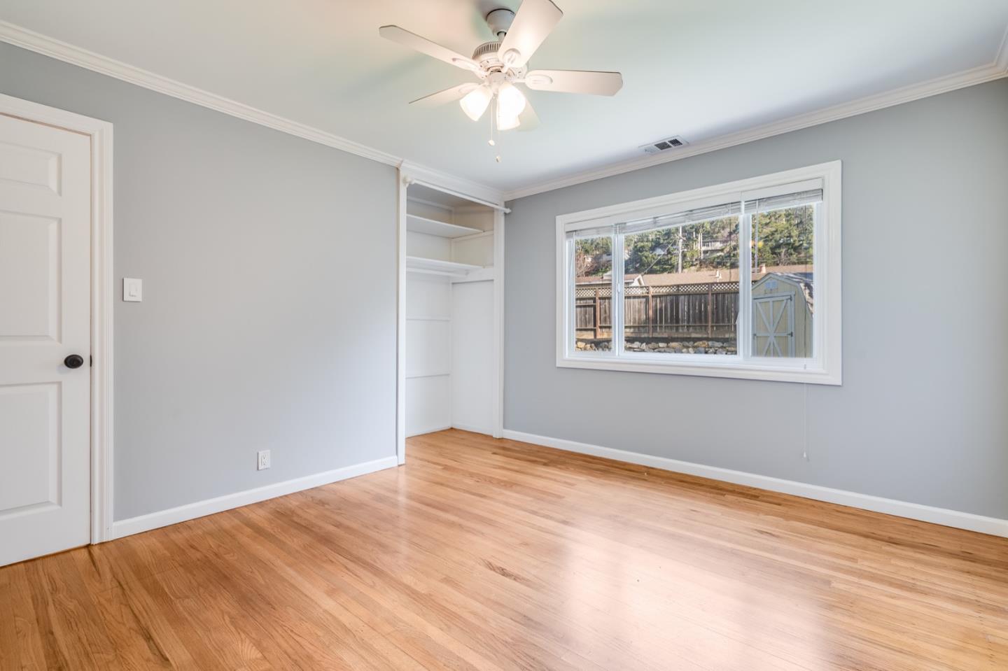 1419 Madeira Drive Pacifica, CA 94044 - Photo 31 of 66 a view of an empty room with window and chandelier fan