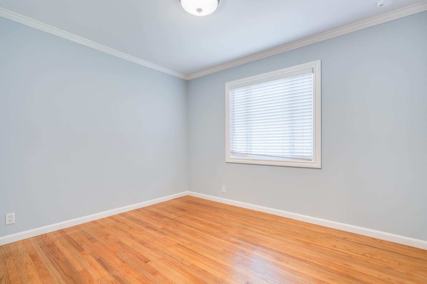 1419 Madeira Drive Pacifica, CA 94044 - Photo 37 of 66 a view of an empty room with wooden floor and a window