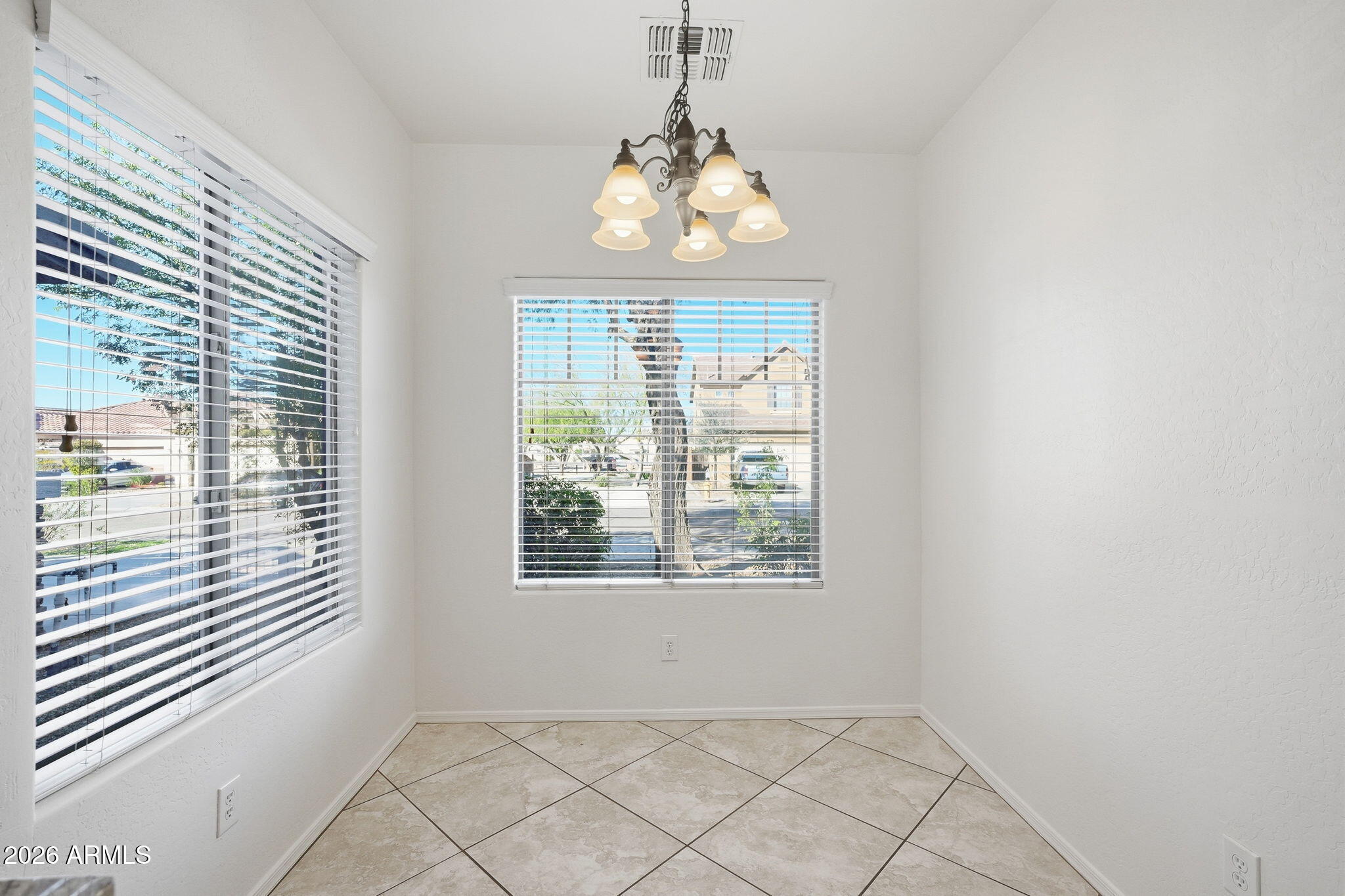 8851 West Payson Road Tolleson, AZ 85353 - Photo 12 of 32 an empty room with windows and entrance