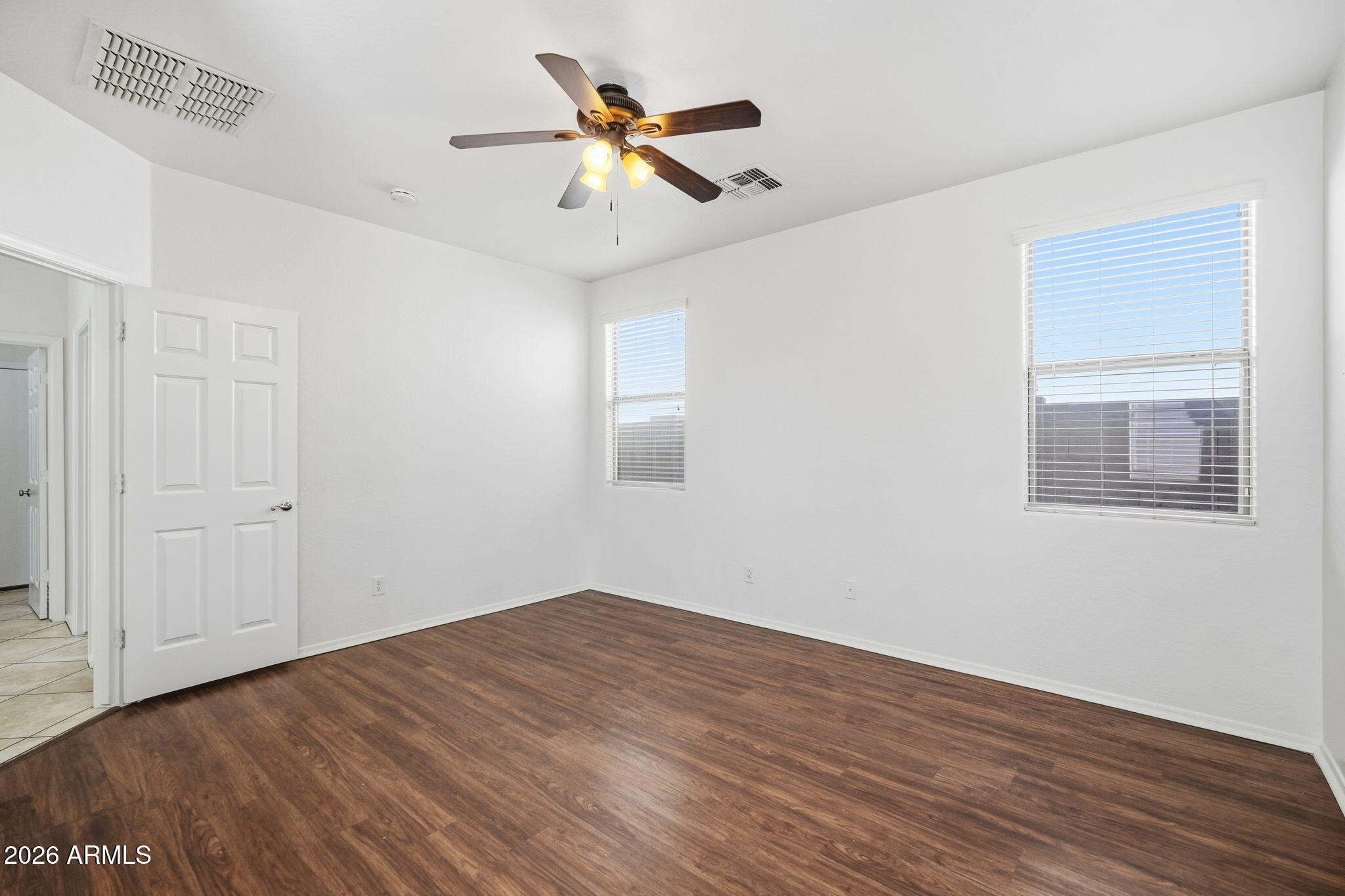 8851 West Payson Road Tolleson, AZ 85353 - Photo 23 of 32 a view of room with wooden floor and ceiling fan