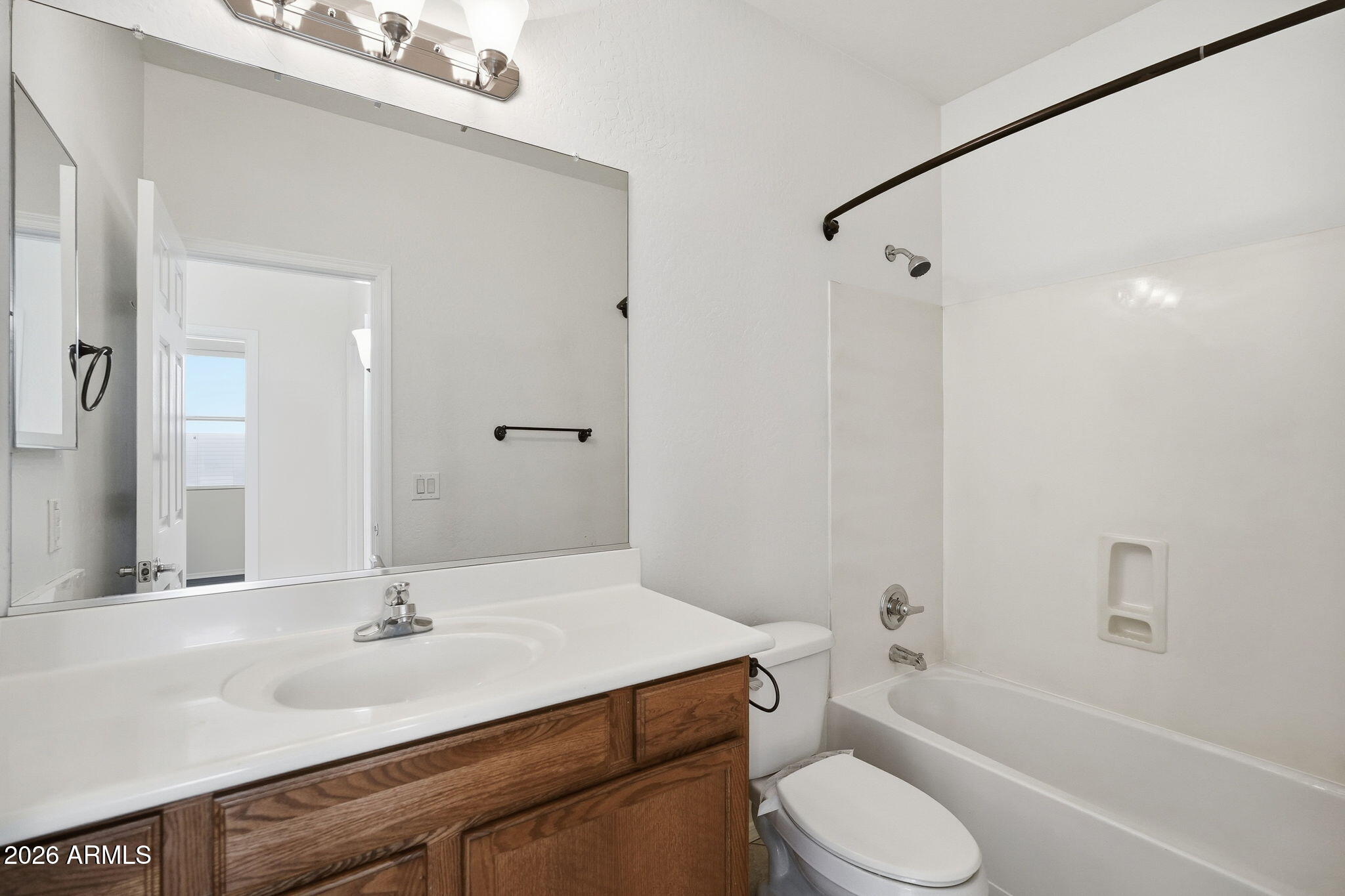 8851 West Payson Road Tolleson, AZ 85353 - Photo 25 of 32 a bathroom with a sink toilet vanity and shower