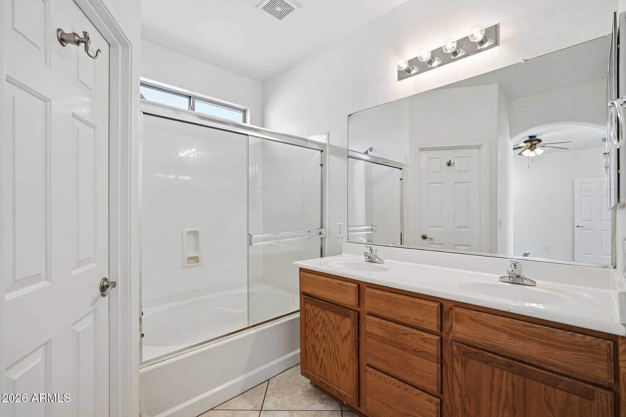 8851 West Payson Road Tolleson, AZ 85353 - Photo 26 of 32 a bathroom with a shower sink vanity and mirror