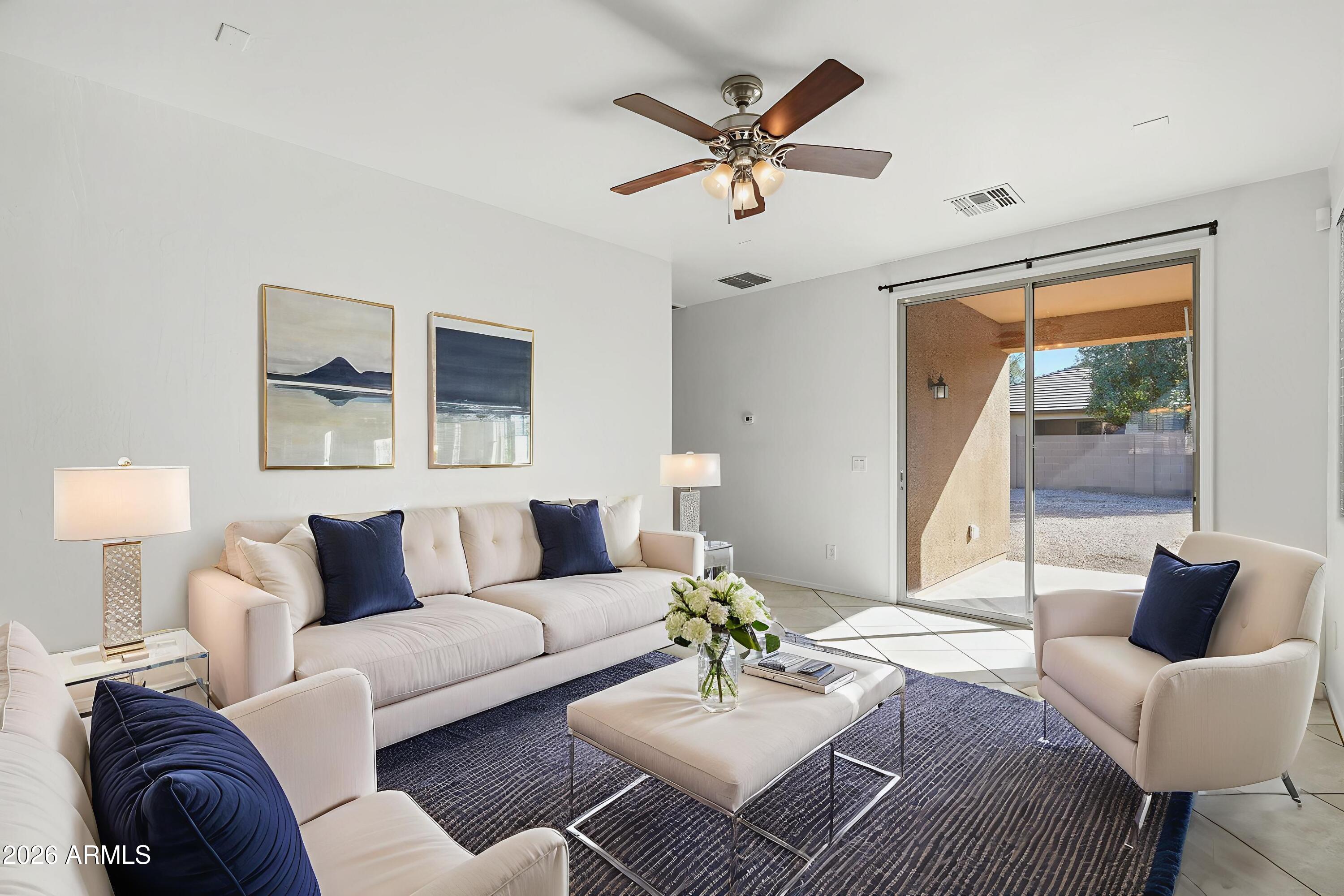 8851 West Payson Road Tolleson, AZ 85353 - Photo 2 of 32 a living room with furniture and a large window