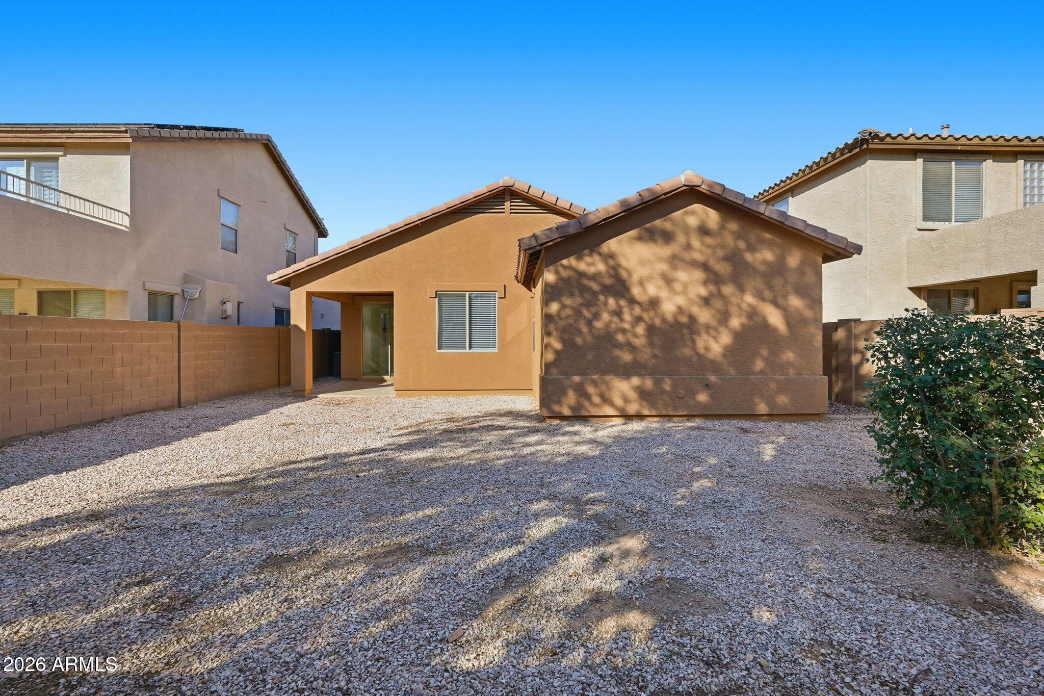 8851 West Payson Road Tolleson, AZ 85353 - Photo 31 of 32 a front view of a house with a yard and garage