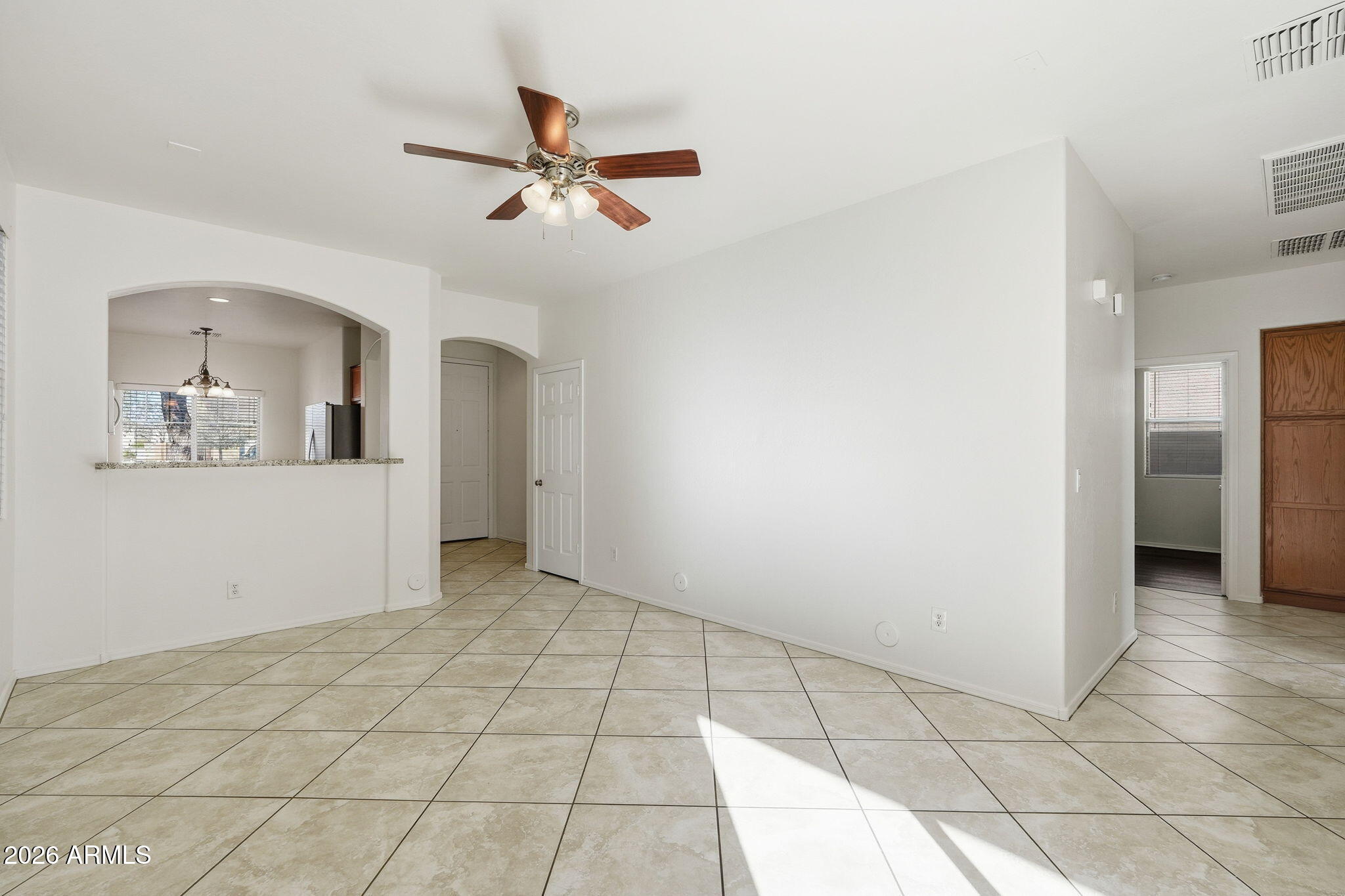 8851 West Payson Road Tolleson, AZ 85353 - Photo 5 of 32 a view of a livingroom with a chandelier fan and windows