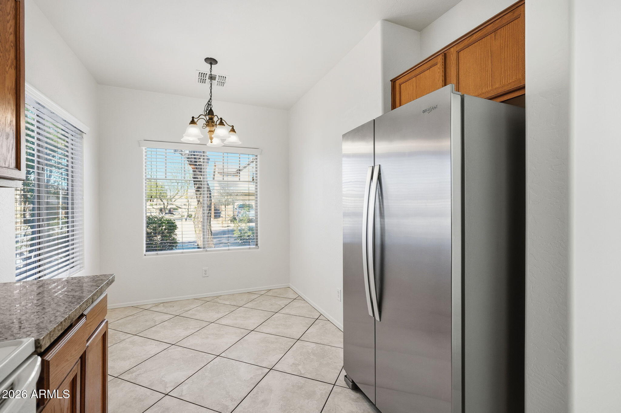 8851 West Payson Road Tolleson, AZ 85353 - Photo 9 of 32 a kitchen with stainless steel appliances granite countertop a refrigerator and a sink