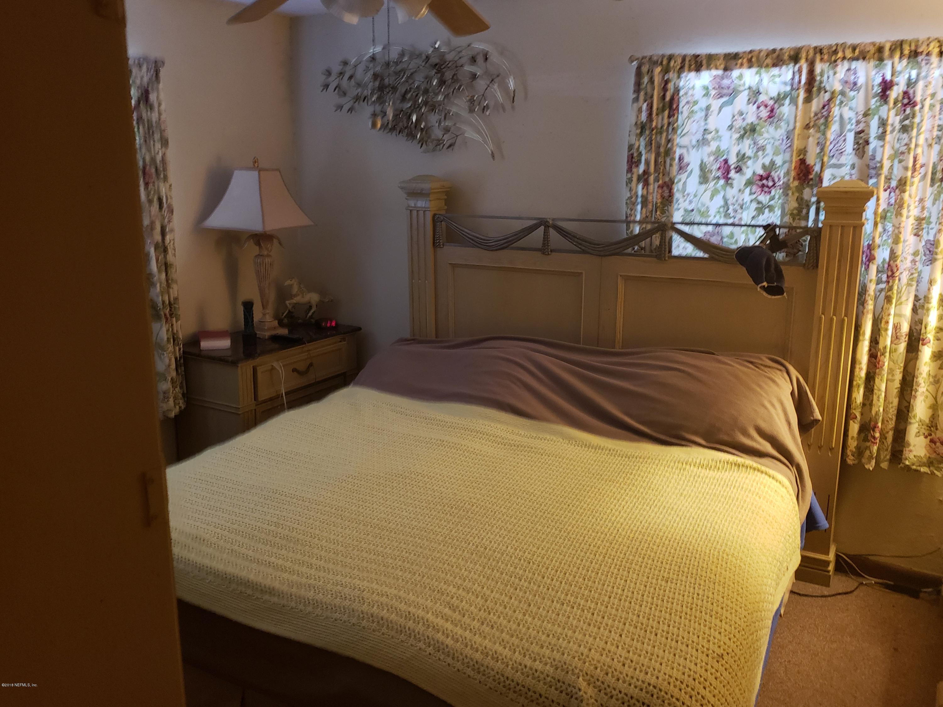 2136 Dean Road Jacksonville, FL 32216 - Photo 7 of 9 a bedroom with a bed and a window