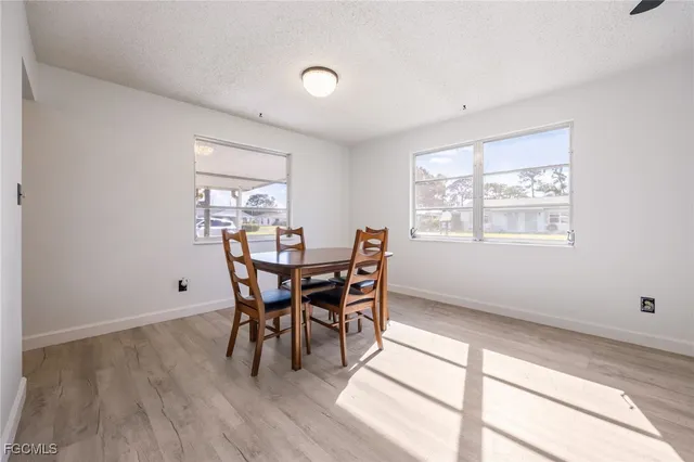 a dining room with wooden floor and a window