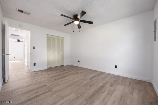 a view of empty room with wooden floor