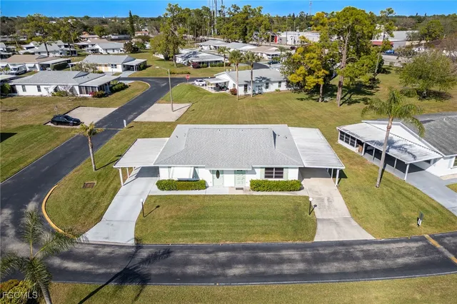 an aerial view of residential houses with outdoor space and swimming pool