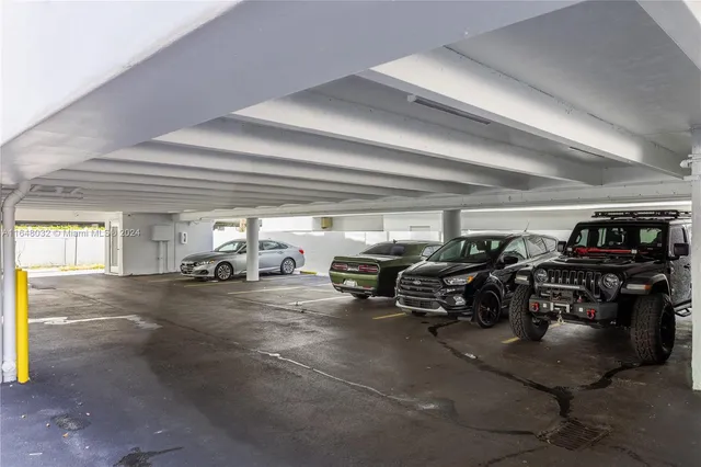 a view of parking garage with cars