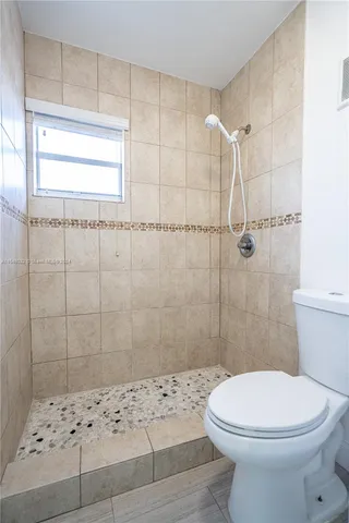 a bathroom with a toilet and shower