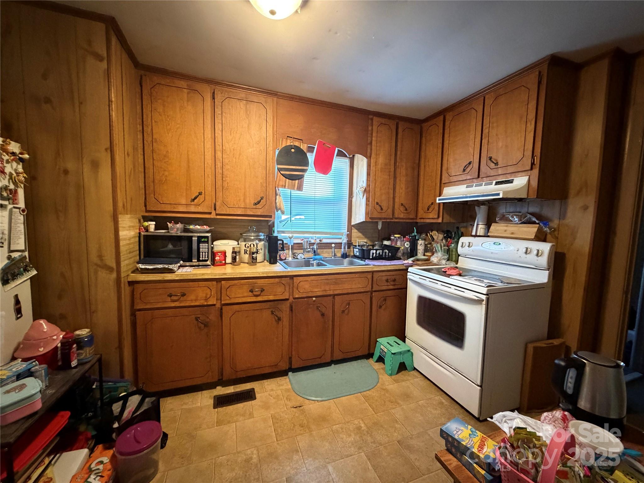 928 Bost Street Albemarle, NC 28001 - Photo 7 of 20 a kitchen with granite countertop wooden cabinets and white appliances