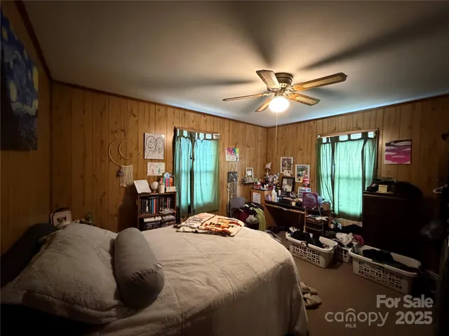 a bedroom with a bed and a mirror