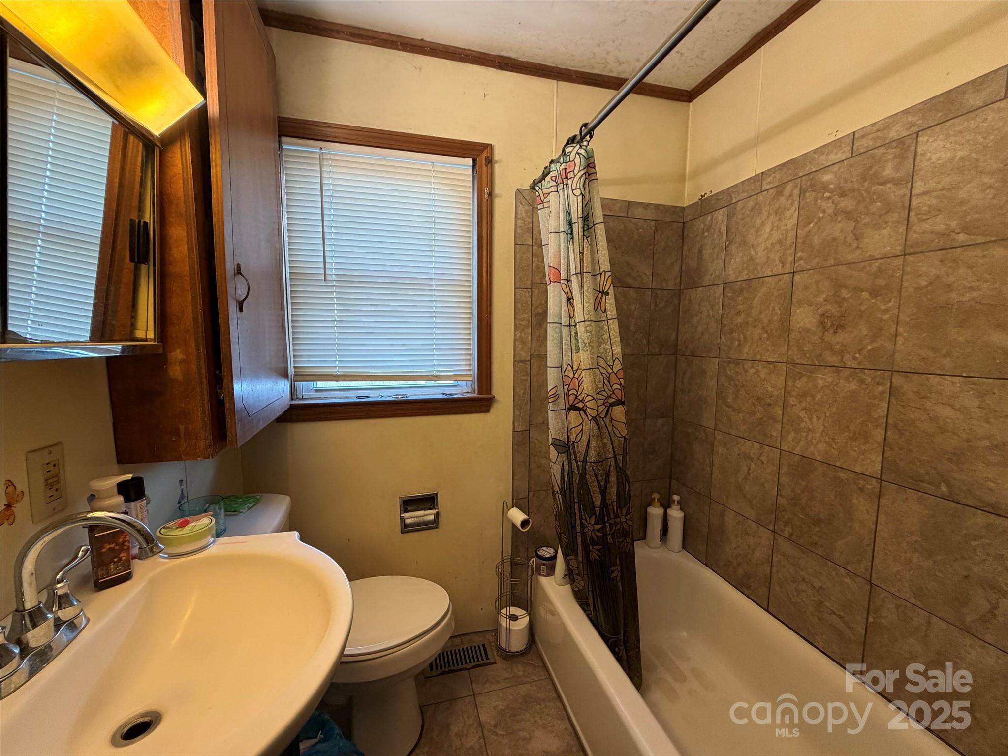 928 Bost Street Albemarle, NC 28001 - Photo 10 of 20 a bathroom with a sink toilet and shower
