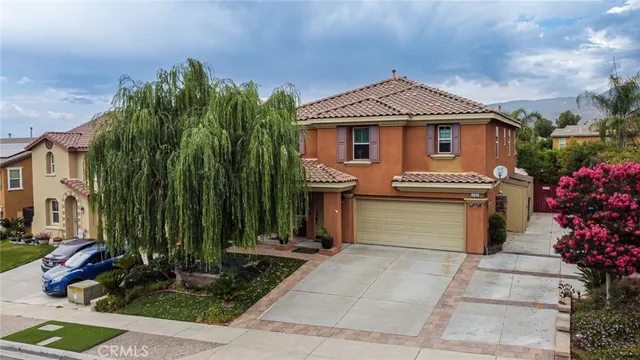 a front view of a house with a garden
