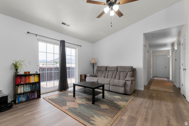 25 West Ridge Road, Unit 25 Saratoga Springs, UT 84045 - Photo 2 of 22 Spacious living area featuring wood-finish flooring, a sliding glass door leading to an outdoor patio, and a ceiling fan