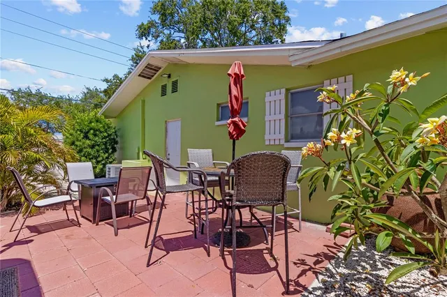 a view of an chairs and table in the patio