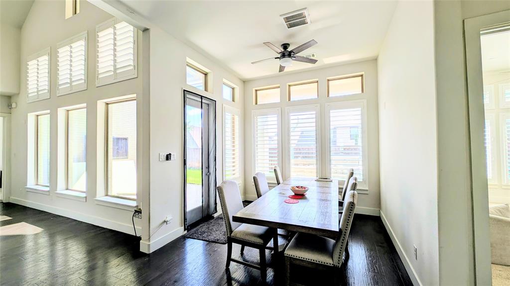 8933 Frostweed Road Frisco, TX 75035 - Photo 10 of 36 a view of a dining room with furniture and wooden floor