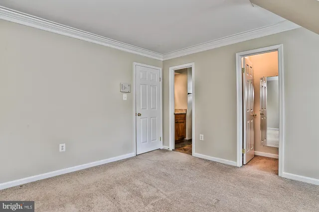 a view of an empty room and closet area