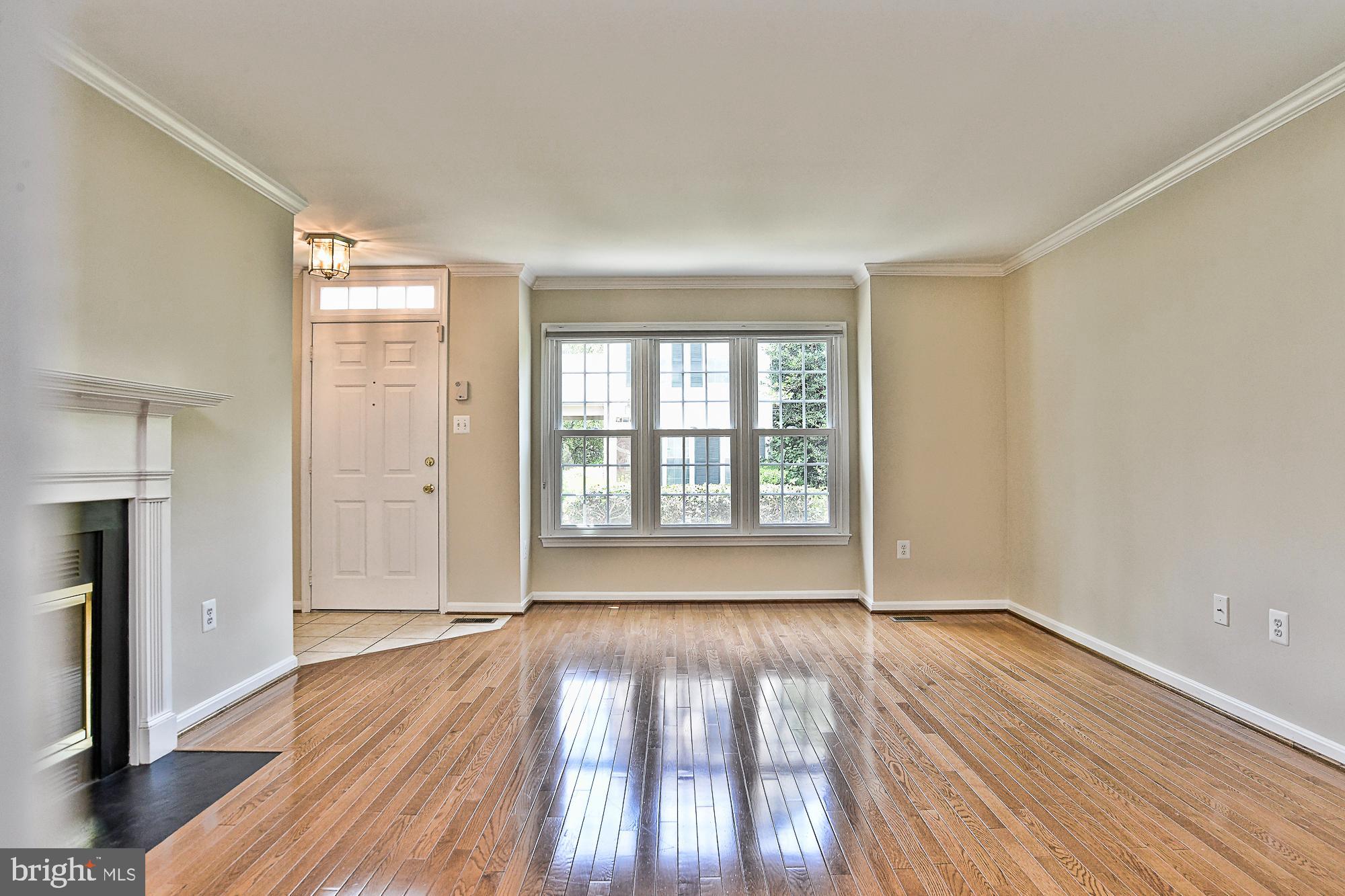 12817 Mill Brook Court Woodbridge, VA 22192 - Photo 7 of 34 a view of an empty room with wooden floor and a window