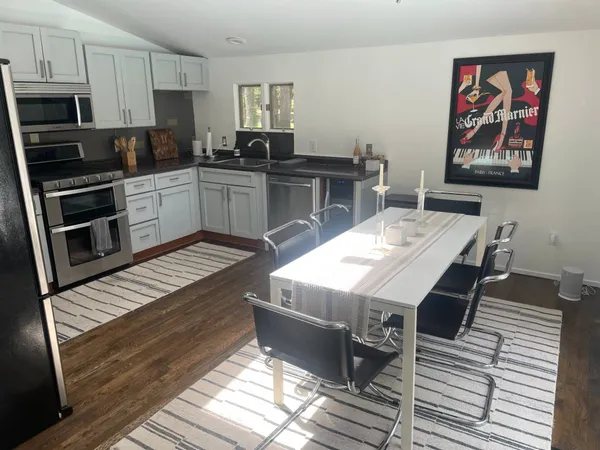 a kitchen with stainless steel appliances kitchen island granite countertop a stove a sink and a microwave