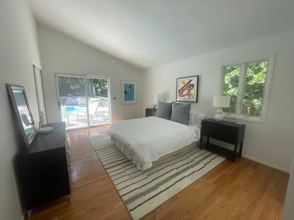 a bedroom with a bed and a large window