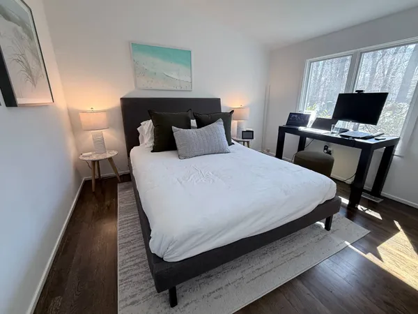 a bedroom with a bed and wooden floor