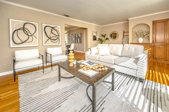 a living room with furniture a fireplace and a rug