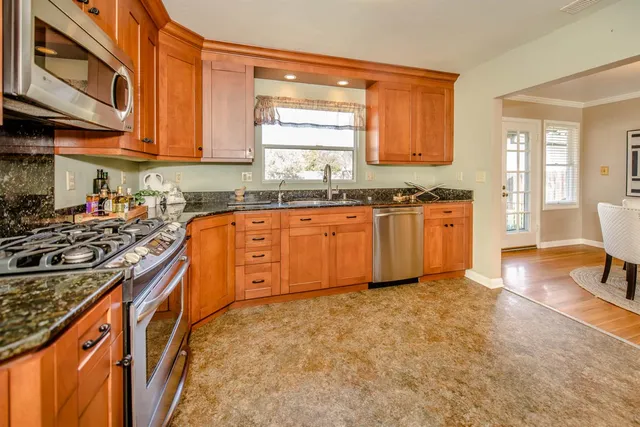 a view of a workspace with wooden floor and a window