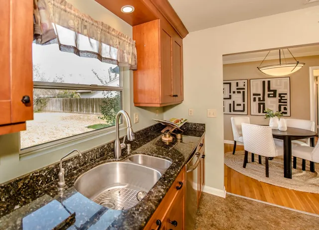 a view of a room with furniture and wooden floor