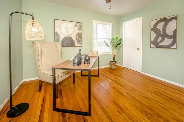 a bed sitting in a bedroom next to a window