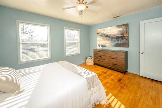 a view of a chair and table in backyard of the house