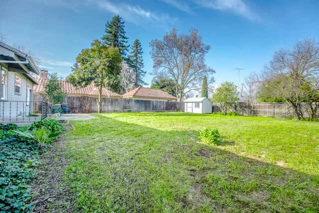 a view of house with backyard and garden