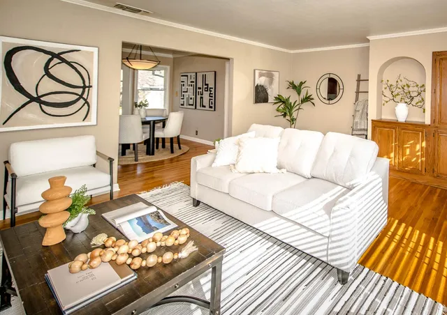 a living room with furniture and wooden floor