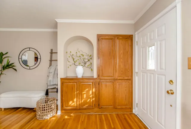 a view of a livingroom with wooden floor and a large window