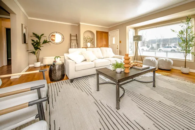 a living room with fireplace furniture and a floor to ceiling window