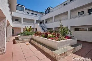 a view of a patio with dining table and chairs