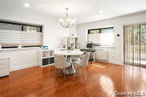 21 Canterbury Road, Unit 6 Great Neck, NY 11021 - Photo 13 of 32 a view of a dining room with furniture window and wooden floor