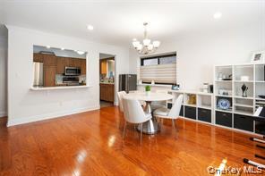 21 Canterbury Road, Unit 6 Great Neck, NY 11021 - Photo 14 of 32 a living room with furniture a large window and wooden floor
