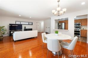 21 Canterbury Road, Unit 6 Great Neck, NY 11021 - Photo 15 of 32 a view of a dining room with furniture and wooden floor