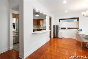 21 Canterbury Road, Unit 6 Great Neck, NY 11021 - Photo 16 of 32 a view of kitchen with refrigerator stove and wooden floor