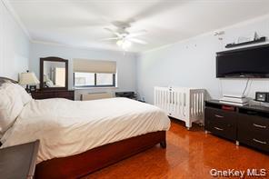 21 Canterbury Road, Unit 6 Great Neck, NY 11021 - Photo 18 of 32 a bedroom with a bed and a flat screen tv