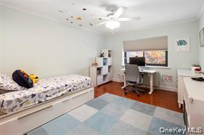 21 Canterbury Road, Unit 6 Great Neck, NY 11021 - Photo 24 of 32 a bedroom with furniture and a wooden floor