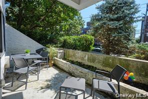 21 Canterbury Road, Unit 6 Great Neck, NY 11021 - Photo 28 of 32 a view of a chairs and table in patio