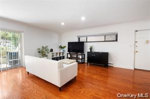 21 Canterbury Road, Unit 6 Great Neck, NY 11021 - Photo 5 of 32 a living room with furniture and a flat screen tv