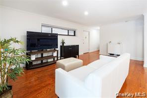 21 Canterbury Road, Unit 6 Great Neck, NY 11021 - Photo 6 of 32 a bedroom with furniture and a fireplace