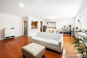 21 Canterbury Road, Unit 6 Great Neck, NY 11021 - Photo 7 of 32 a living room with furniture and a large window