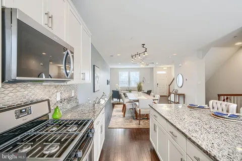 a kitchen with a sink stove cabinets and refrigerator